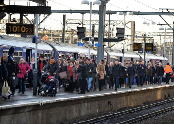 Commuters on a platform at Leeds Station as political pressure grows for more transport investment in the North from MPs like Rachel Reeves.
