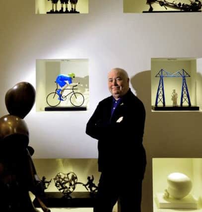120419    Artist Mackenzie Thorpe  in front of his sculpture wall  at his gallery in Richmond    YP Mag