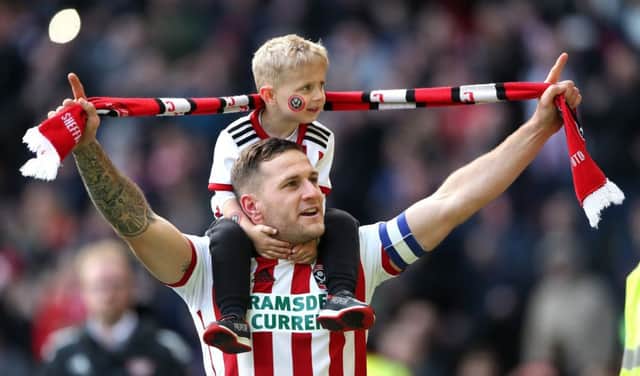Sheffield United's Billy Sharp with his son after the final whistle signalled victory over Ipswich Town and promotion to the Premier League (Picture: Nick Potts/PA Wire).