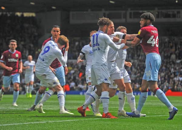 Patrick Bamford goes down challenged by Villa's Anwar El Ghazi as tempers boil over.