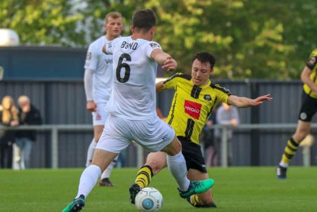 Harrogate Towns Jack Emmett challenges Fyldes goalscorer Andy Bond. Picture: Matt Kirkham