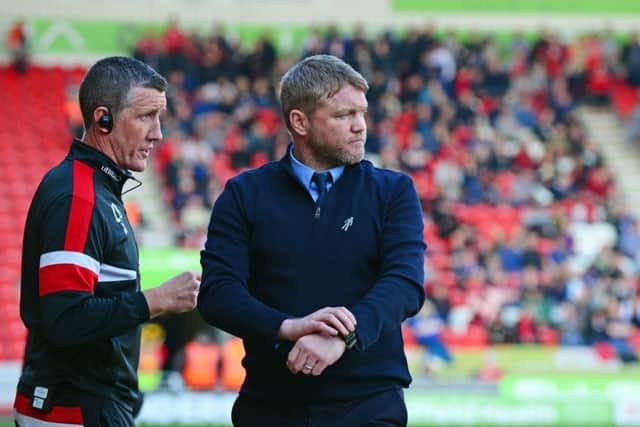 Doncaster Rovers manager Grant McCann, right, and his assistant Cliff Byrne are one win from taking the side into the League One play-offs (Picture: Marie Caley).