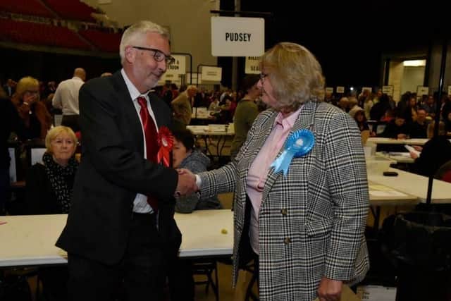 Labour's Richard Lewis, Leeds City Council's portfolio holder for transport, congratulates Tory Trish Smith after she ousts him from his Pudsey seat.