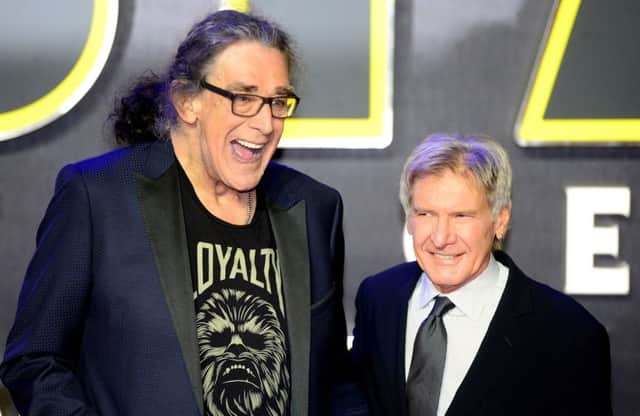 Peter Mayhew, who has died at the age of 74, and Harrison Ford