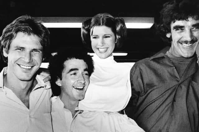 From left: Harrison Ford who played Han Solo, Anthony Daniels who played the robot C3P0, Carrie Fisher who played the princess, and Peter Mayhew who played the Wookie, Chewbacca, during a break from the filming in 1978