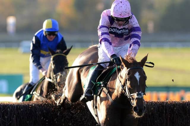 Silviniaco Conti and Ruby Walsh jump the last fence on their way to victory in the Charlie Hall Chase at Wetherby in 2012.