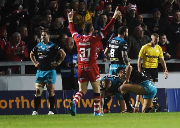 Leeds Rhinos are dejected as Salford Red Devils celebrate (Picture: Jonathan Gawthorpe).