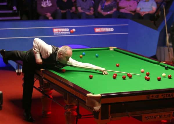 John Higgins during day fourteen of the 2019 Betfred World Championship at The Crucible, Sheffield.