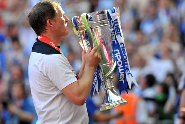 With the play-off trophy as Huddersfield manager back in 2007 (Picture: Bruce Rollinson)