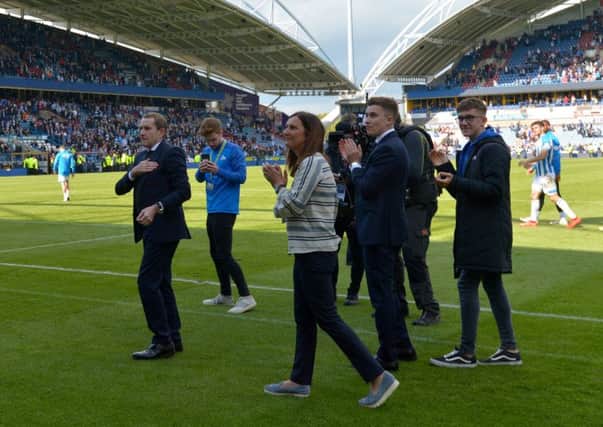 Huddersfield Town chairman Dean Hoyle, left, salutes the fans after his final match at the John Smith's Stadium, a draw with Manchester United (Picture: Anthony Devlin/PA Wire).