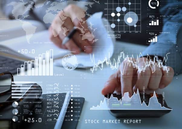 ADOBE STOCK
Investor analyzing stock market report and financial dashboard with business intelligence (BI), with key performance indicators (KPI).businessman hand working with finances about cost and calculator.