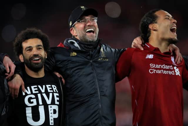 Liverpool's Mohamed Salah (left), manager Jurgen Klopp (centre) and Virgil van Dijk celebrate at Anfield. Picture: Peter Byrne/PA.