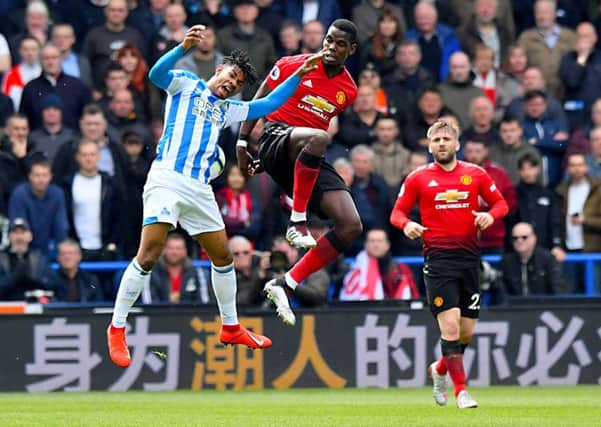 Huddersfield Town's Juninho Bacuna (left) and Manchester United's Paul Pogba had a right old tussle on Sunday (Picture: PA)