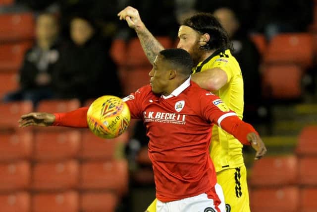 Victor Adeboyejo and John Brayford challenge for a high ball. during the Barnsley FC v Burton Albion clash in February (Picture: Bruce Rollinson)