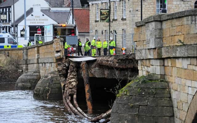 Police and agency staff stand at the entrance to the historic Tadcaster Bridge which partially collapsed in 2015. Picture: Anthony Chappel-Ross