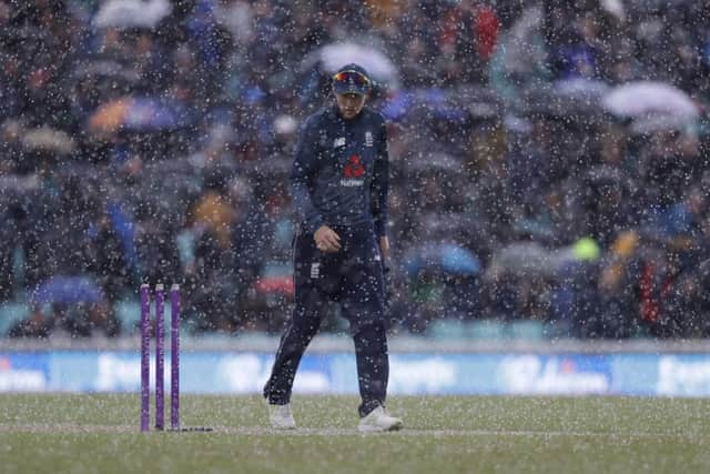 England's Joe Root leaves the pitch as a sudden hail shower halts play between England and Pakistan at The Oval. The game was later abandioned. Picture: AP/Kirsty Wigglesworth
