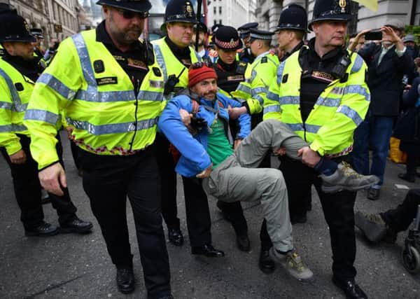 Police officers remove climate change activists from the recent Extinction Rebellion protests in London.