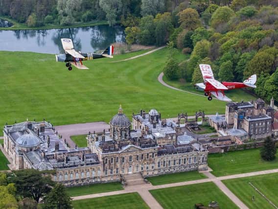 Pilots from the Royal Air Force Benevolent Tiger Moth Squadron, over Castle Howard. Picture by Charlotte Graham.