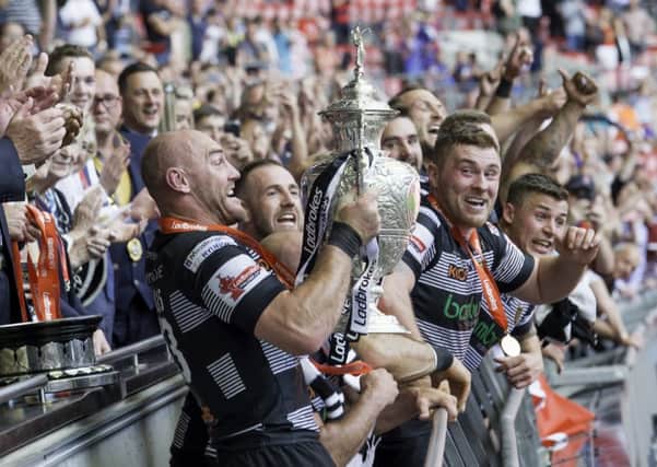 Hull FC captain Gareth Ellis holds the Ladbrokes Challenge Cup trophy aloft as his side defeat Wigan.