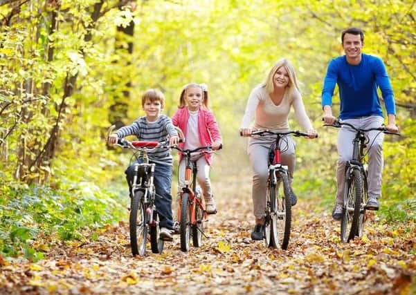 A family enjoy a cycling trail.
