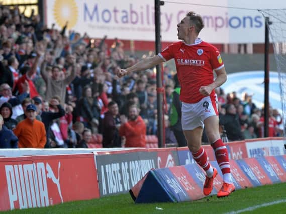 Cauley Woodrow celebrates a goal against Coventry in March.