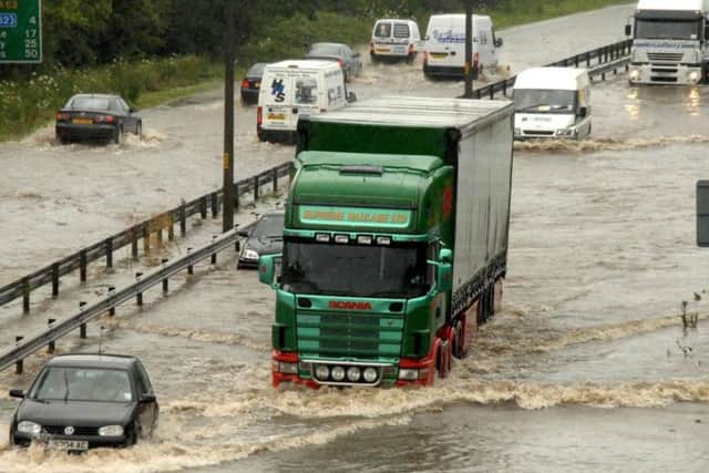 Motorists drive through deep flood water on the A63 into Hull on June 25, 2007.