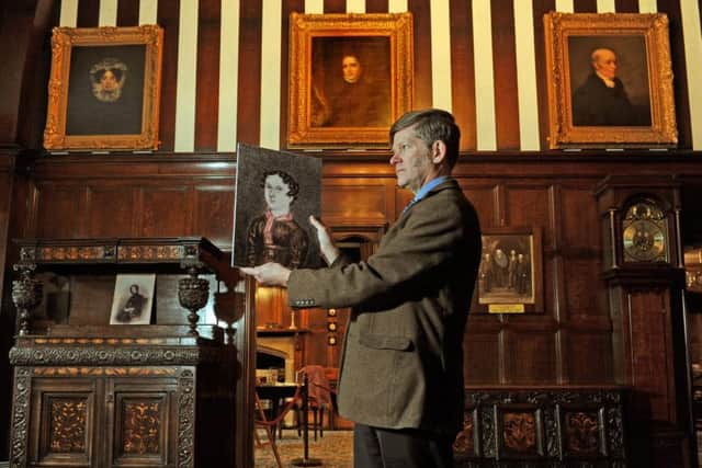 Museum manager Richard Macfarlane with a portrait of Anne Lister