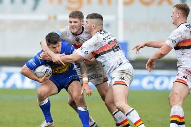 Leeds Rhinos' Tom Briscoe is held by James Green and Matty Storton of Bradford (Picture: Bruce Rollinson)