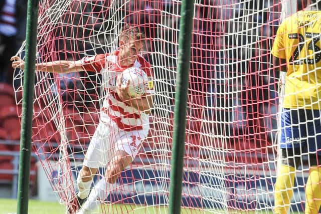 Doncaster Rovers' Matty Blair collects the ball after his goal against Charlton Athletic (Picture: Dean Atkins).