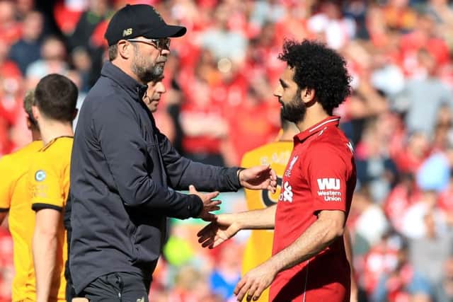Liverpool manager Jurgen Klopp embraces Mohamed Salah after missing out on the Premier League title. Picture: Peter Byrne/PA