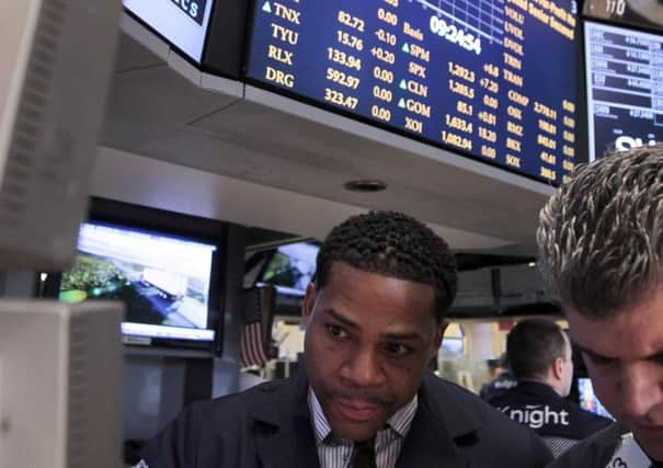 Bernard Wheeler, left, of Knight Capital, and John Panin of JNK Securities, work on the floor of the New York Stock Exchange on Wednesday, June 6, 2012.  An early charge on Wall Street Wednesday put the Dow Jones industrial average on track for a second day of gains, up 154 points at 12,242 in the first hour of trading.  (AP Photo/Bebeto Matthews)