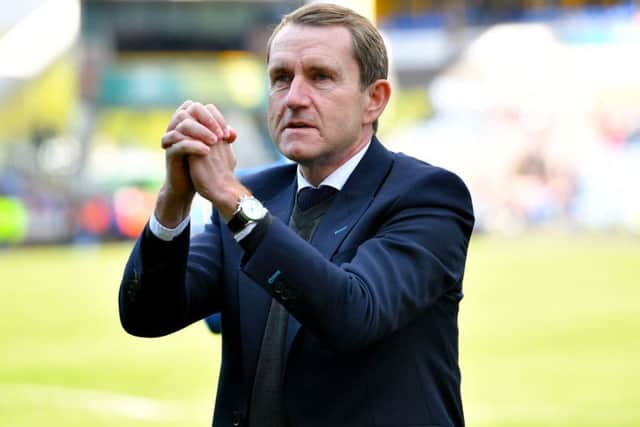 Departing Huddersfield Town chairman Dean Hoyle salutes the fans after his final match at the John Smith's Stadium (Picture: PA)