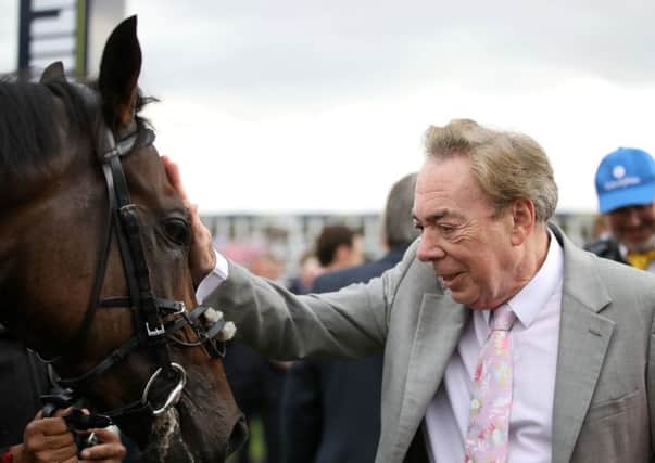 Composer Andrew Lloyd Webber celebrates Dante contender Too Darn Hot's victory in the Champagne Stakes at Doncaster on St Leger day.