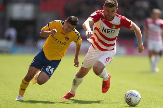 Wembley target: Charlton Athletic's Josh Cullen, left, and Doncaster Rovers' Andy Butler battle for the ball at the Keepmoat Stadium.