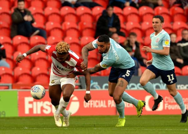 NEW FACE: Ben Richards-Everton battles with Doncaster Rovers' Mallik Wilks at the Keepmoat Stadium. 
Picture: Bruce Rollinson