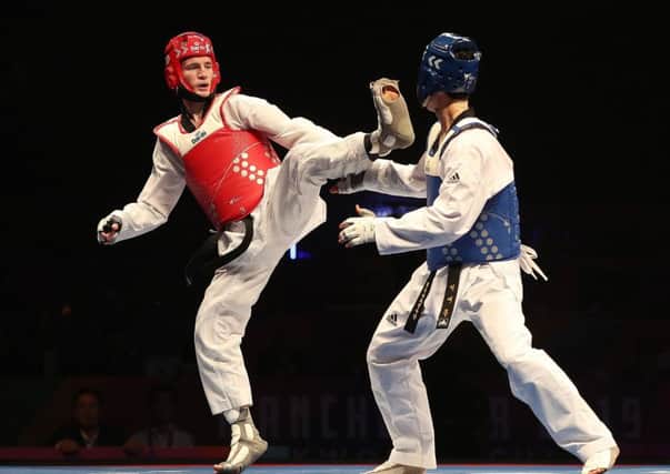 Great Britain's Bradly Sinden (left) on his way to winning his semi final match against Korea's Dae-Hoon Lee, during day two of the World Taekwondo Championships at Manchester Arena. (Picture: Martin Rickett/PA Wire)