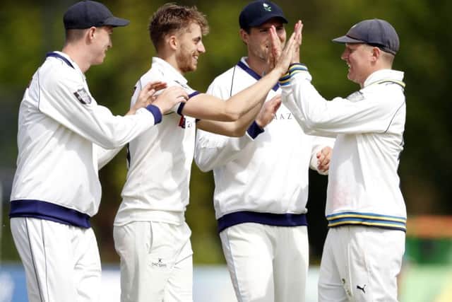 Ben Coad is congratulated by his team-mates after taking the wicket of Ollie Robinson. Picture: Max Flego.