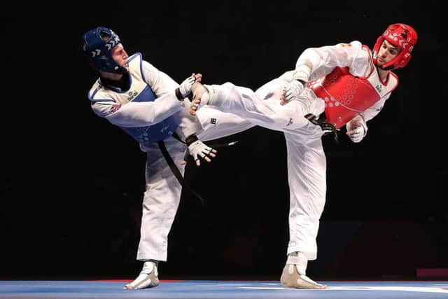 Great Britain's Bradly Sinden (left) on his way to winning the Men's -68kkg final against Spain's Javier Perez Polo at the World Taekwondo Championships at Manchester Arena. Picture: Martin Rickett/PA