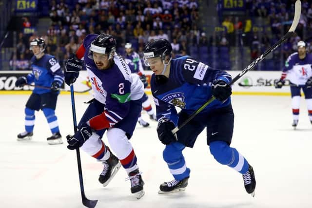 FOOT RACE: GB's Dallas Ehrhardt battles with Finland's teenage sensation Kaapo Kakko in Kosice on Friday night. Picture: Martin Rose/Getty Images.