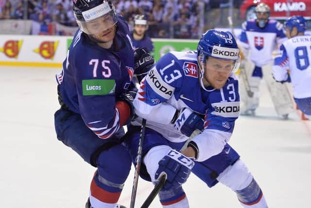 BATTLE: Robert Dowd fights for possession with Slovakia's Michal Kristof during Saturday's Group A clash in Kosice. Picture: Dean Woolley.