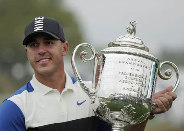 Brooks Koepka holds up the Wanamaker Trophy after winning the PGA Championship.