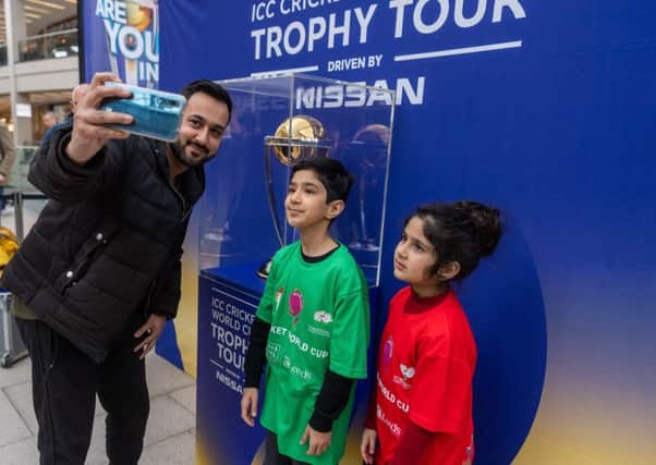 Young fans pose with the World Cup in Leeds ahead of the start of the tournament. Picture: James Hardisty.