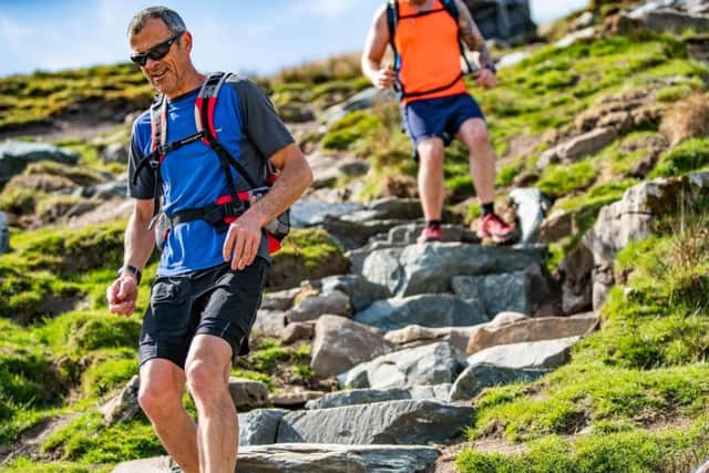 Walkers on the newly repaired Bruntscar path which winds off the peak of Whernside in the Yorkshire Dales National Park. Picture by Andy Kay/ Yorkshire Dales National Park Authority.