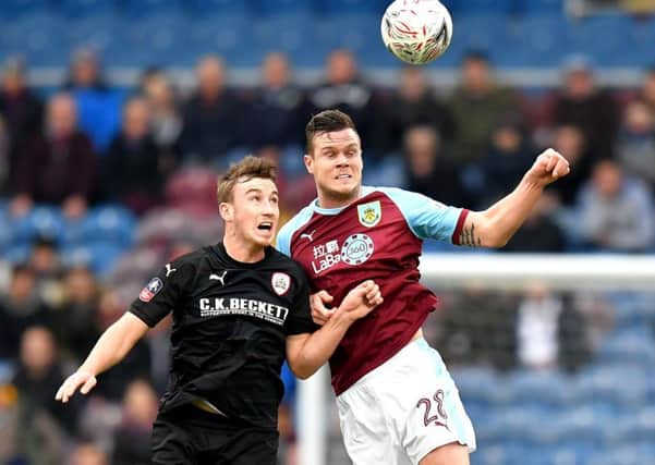 Barnsley's Mike-Steven Bahre, left, duels with Burnley's Kevin Long during the FA Cup tie at Turf Moor in January (Picture: Dave Howarth/PA Wire).