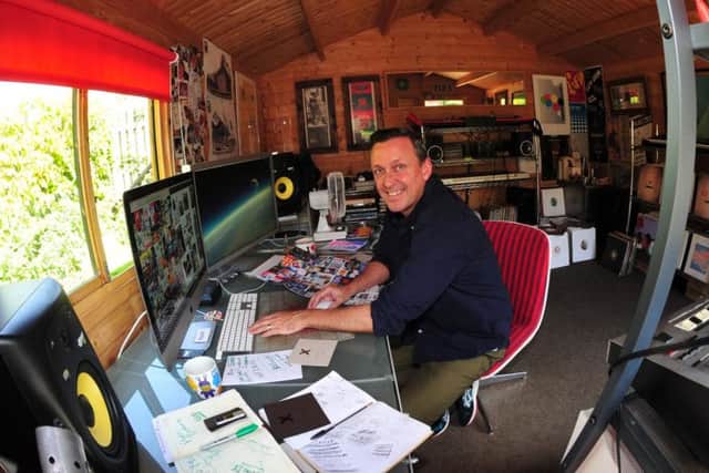 Andy Cole in his garden shed, where he runs Exit Studios graphic design agency.