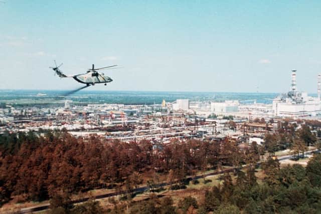 Undated picture of a military helicopter spreading stuff supposed to reduce the contamination of the air full of radioactive elements above the Chernobyl nuclear plant, a few days after its No. 4 reactor's blast in 1986. Picture: STF/AFP/Getty Images