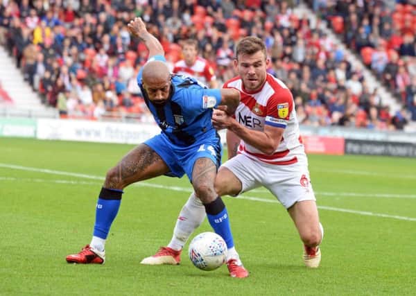 Doncaster Rovers' defender Andy Butler, right, in action against Gillingham (Picture: Marie Caley).