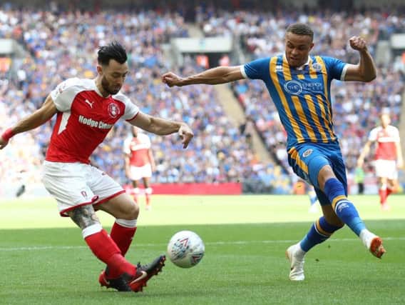 Carlton Morris (right) in action for Shrewsbury Town against Rotherham United in the League One play-off final in May 2018. It was his last competitive appearance due to a serious knee injury.