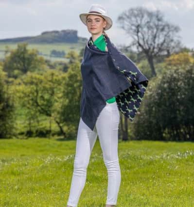 S
Midnight blue check soft tweed cape lined in emerald green fox print with brass fox popper fastenings £125
.  Clothes by Galijah. Charlotte Graham

Pictures.