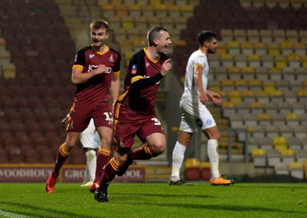 Top game: Paul Caddis celebrates scoring Bradford's third equaliser in the FA Cup replay against Peterbrough.